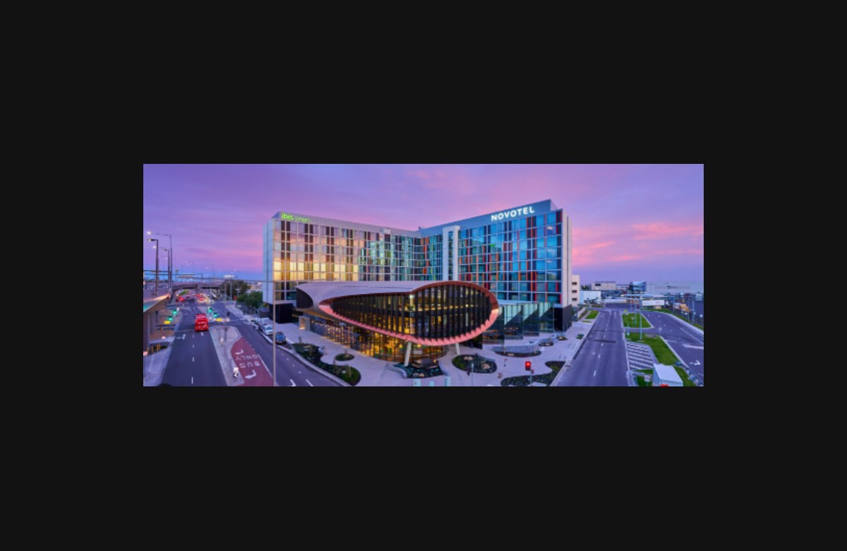 Novotel and ibis Melbourne Airport hotel exterior at dusk