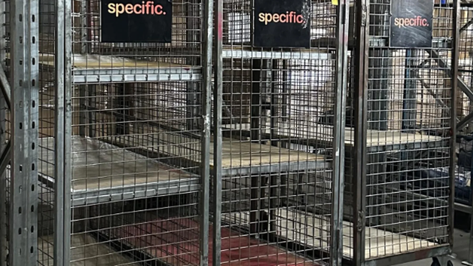 Specific branded warehouse equipment cages used for project logistics